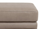 Close-up of a beige leather ottoman on a white background