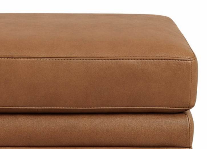Close-up of a brown leather ottoman on a white background