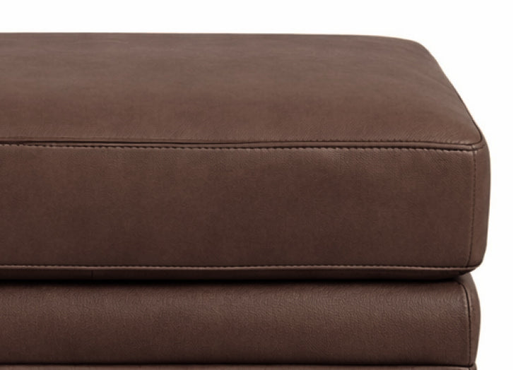 Close-up of a brown leather ottoman on a white background