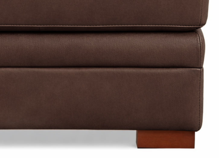 Close-up of a brown leather ottoman with a white background
