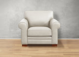 Beige armchair on a wooden floor with a gray wall background