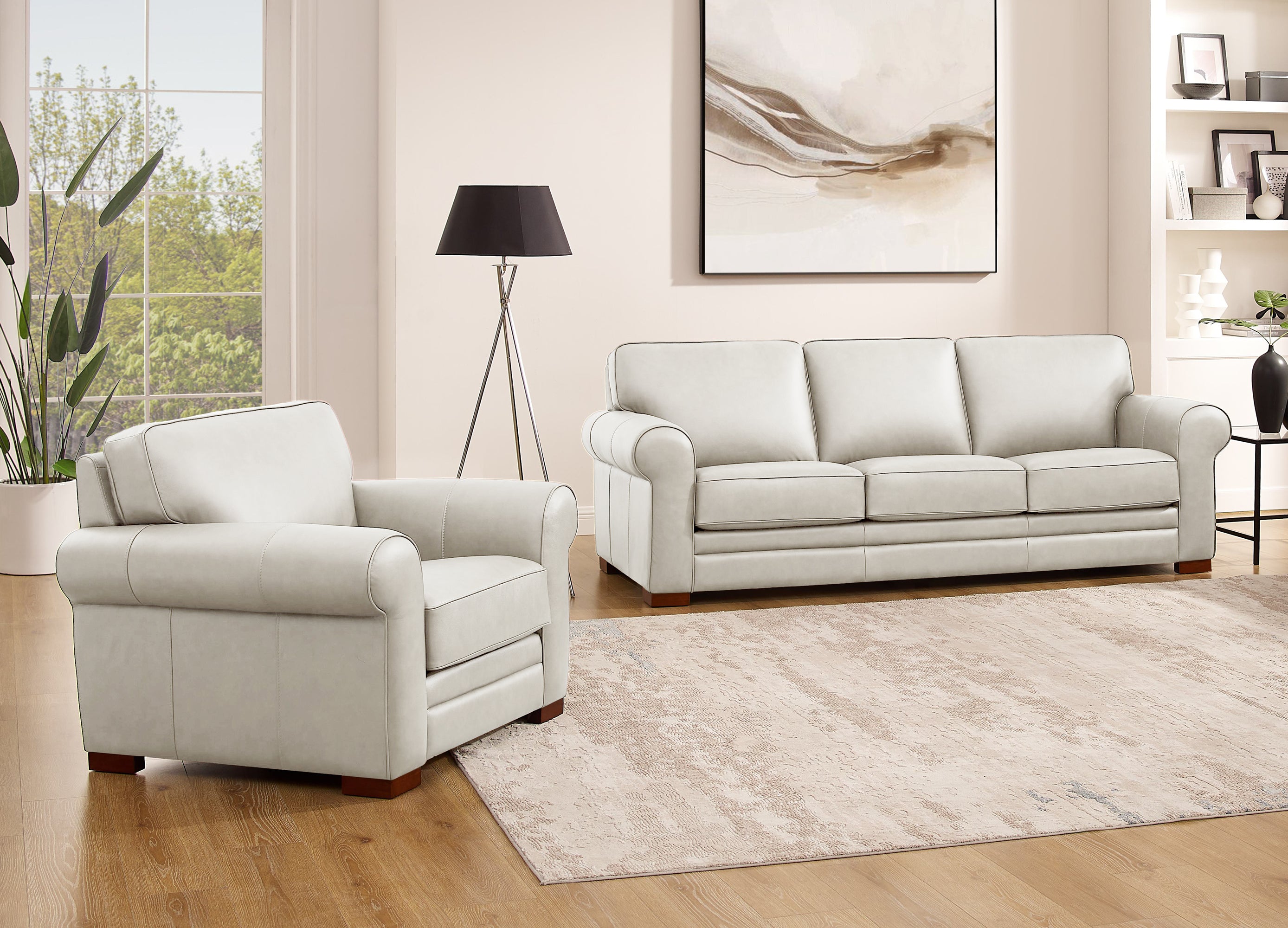Light gray sofa and armchair set in a living room with decor elements.