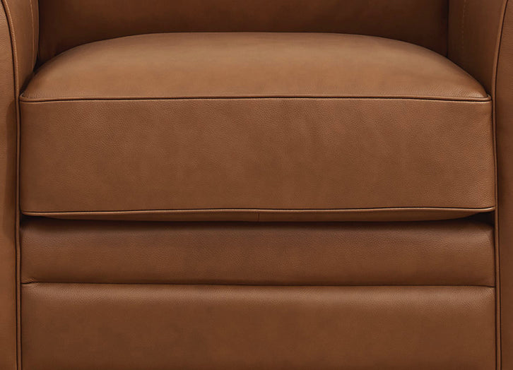 Close-up of a brown leather armchair seat