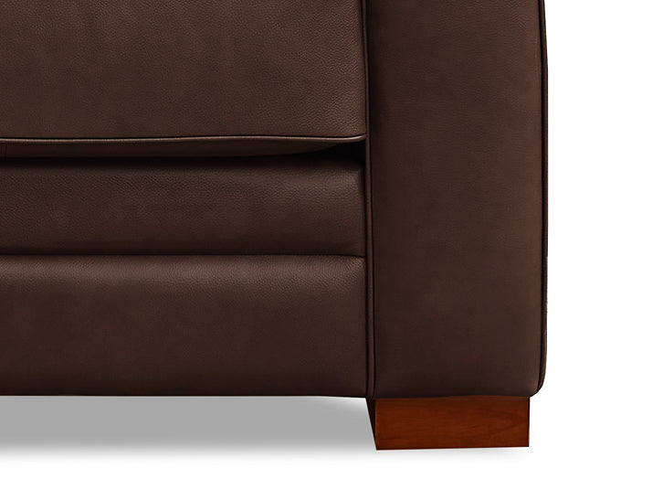 Brown leather sofa corner with wooden leg on a white background