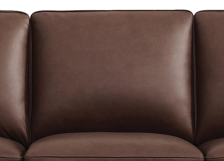 Brown leather sofa with a close-up view of the seat cushion.