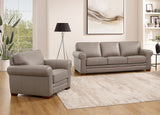 Gray sofa and armchair set in a living room with a rug and lamp.