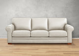 Beige sofa on a wooden floor with a gray wall background