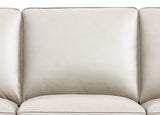 Close-up of a beige leather sofa with a neutral background