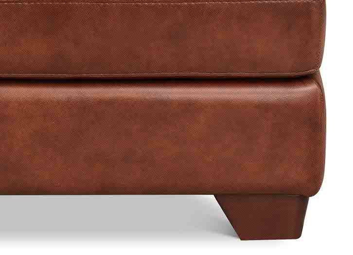 Close-up of a brown leather ottoman on a white background
