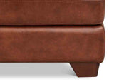 Close-up of a brown leather ottoman on a white background