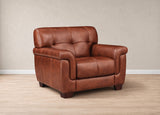 A brown leather armchair with tufted back cushions and rolled arms, shown in a studio setting with a beige wall and light wood floor.