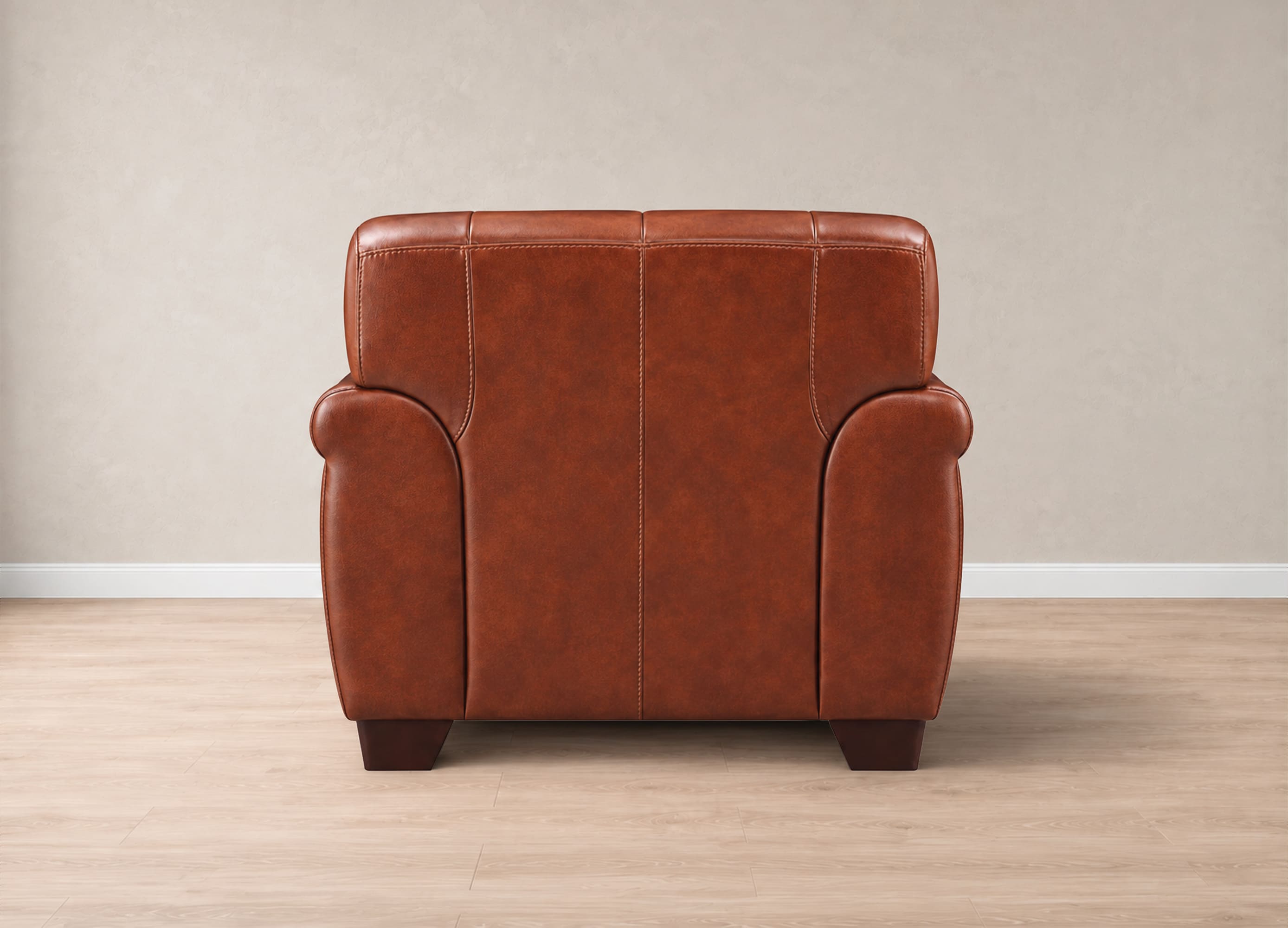 A brown leather armchair shown from the back, positioned against a neutral beige wall on a light wood floor.