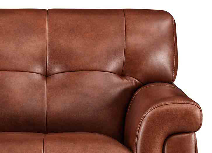 Close-up of a brown leather sofa on a white background