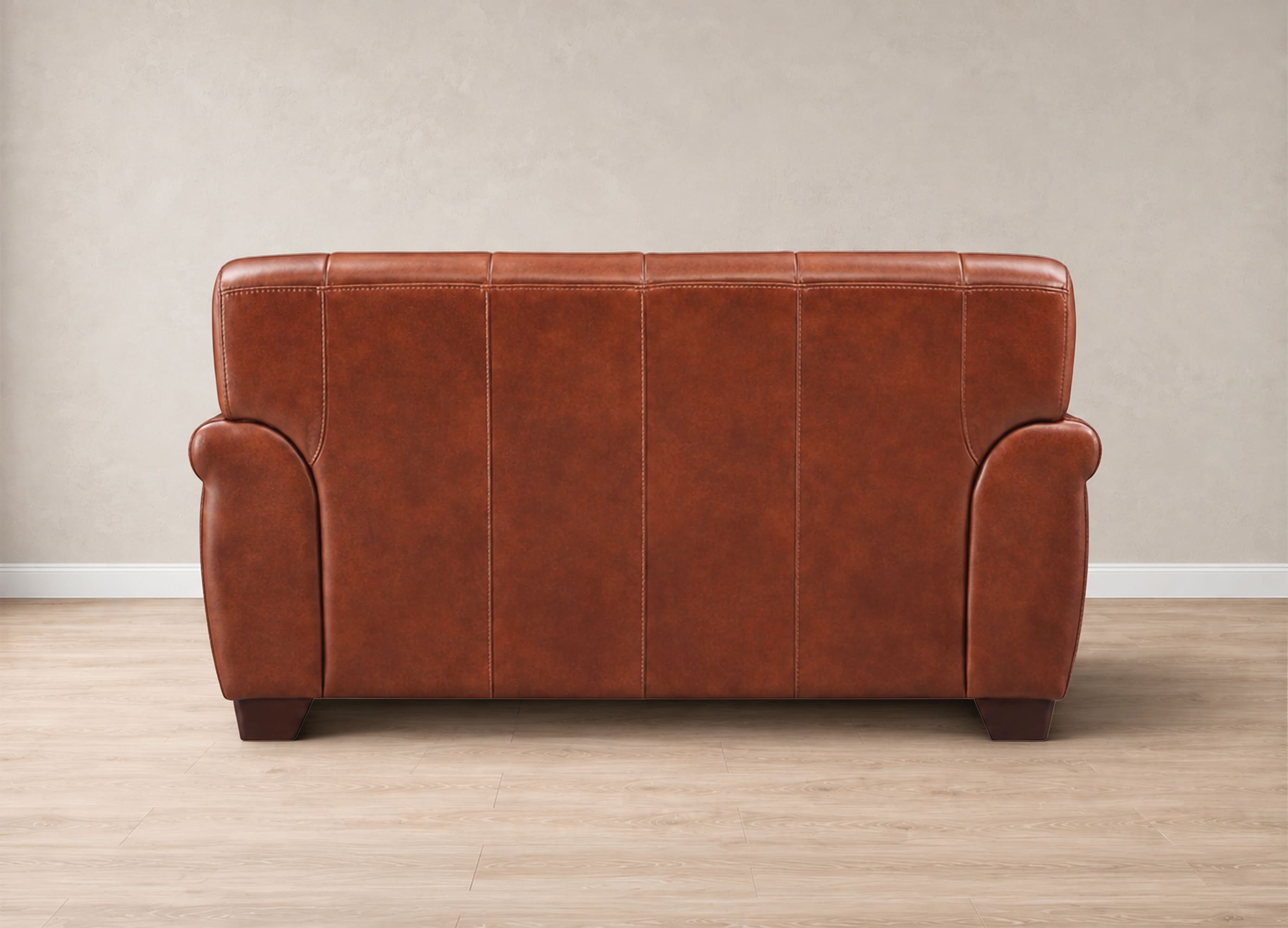 A brown leather loveseat sofa shown from the back, positioned on a light wood floor against a neutral beige wall.