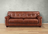 Brown leather sofa against a gray wall on a wooden floor