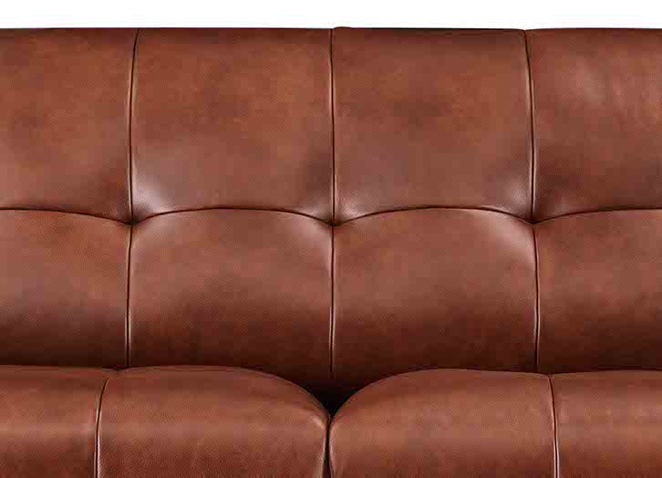 Close-up of a brown leather sofa with visible stitching
