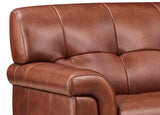 Close-up of a brown leather sofa with visible stitching
