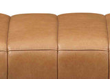 Close-up of a brown leather sofa with visible texture