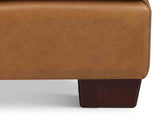 Close-up of a brown leather ottoman on a white background