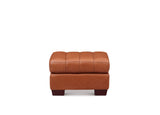 A square brown leather ottoman with a tufted cushioned top and dark wooden legs, shown against a plain white background.