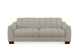 A modern three-seater sofa upholstered in a light beige fabric with vertical channel tufting on the backrest and seat cushions, supported by dark brown wooden legs, shown against a plain white background.