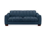 A modern three-seater sofa upholstered in dark blue leather with vertical channel tufting on the backrest and seat, featuring dark brown wooden legs, shown against a plain white background.