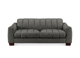 A modern three-seater sofa upholstered in dark gray fabric with vertical channel tufting on the backrest and seat cushions, shown against a plain white background.