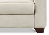 Close-up of a beige sofa with brown legs on a white background