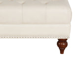 Close-up of a white upholstered chair with wooden legs on a white background