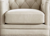 Beige leather armchair with tufted backrest and cushion