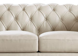 Beige tufted sofa with a close-up view of the backrest and seat.