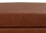 Close-up of a brown leather surface with visible stitching