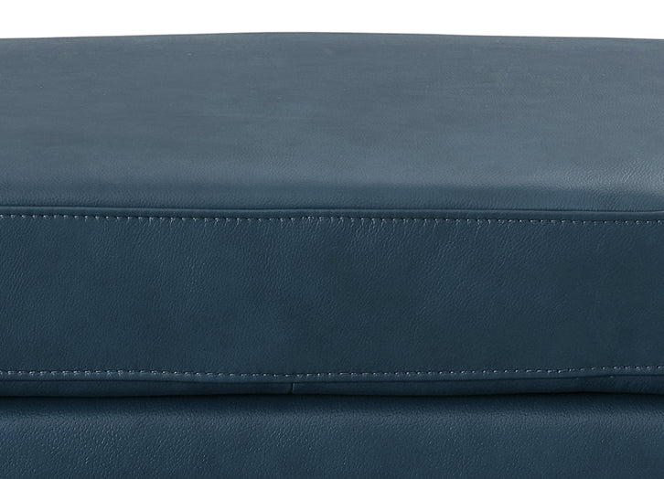 Close-up of a blue leather surface with stitching details