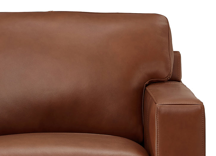 Close-up of a brown leather sofa on a white background