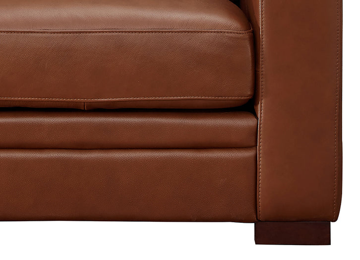 Close-up of a brown leather sofa corner on a white background