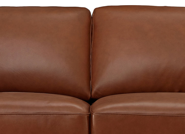 Brown leather sofa with a close-up view of the cushions.