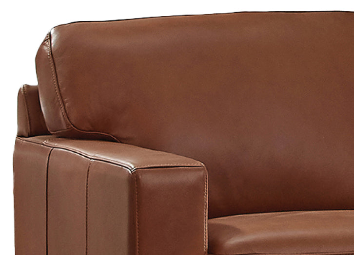 Close-up of a brown leather sofa with visible stitching.