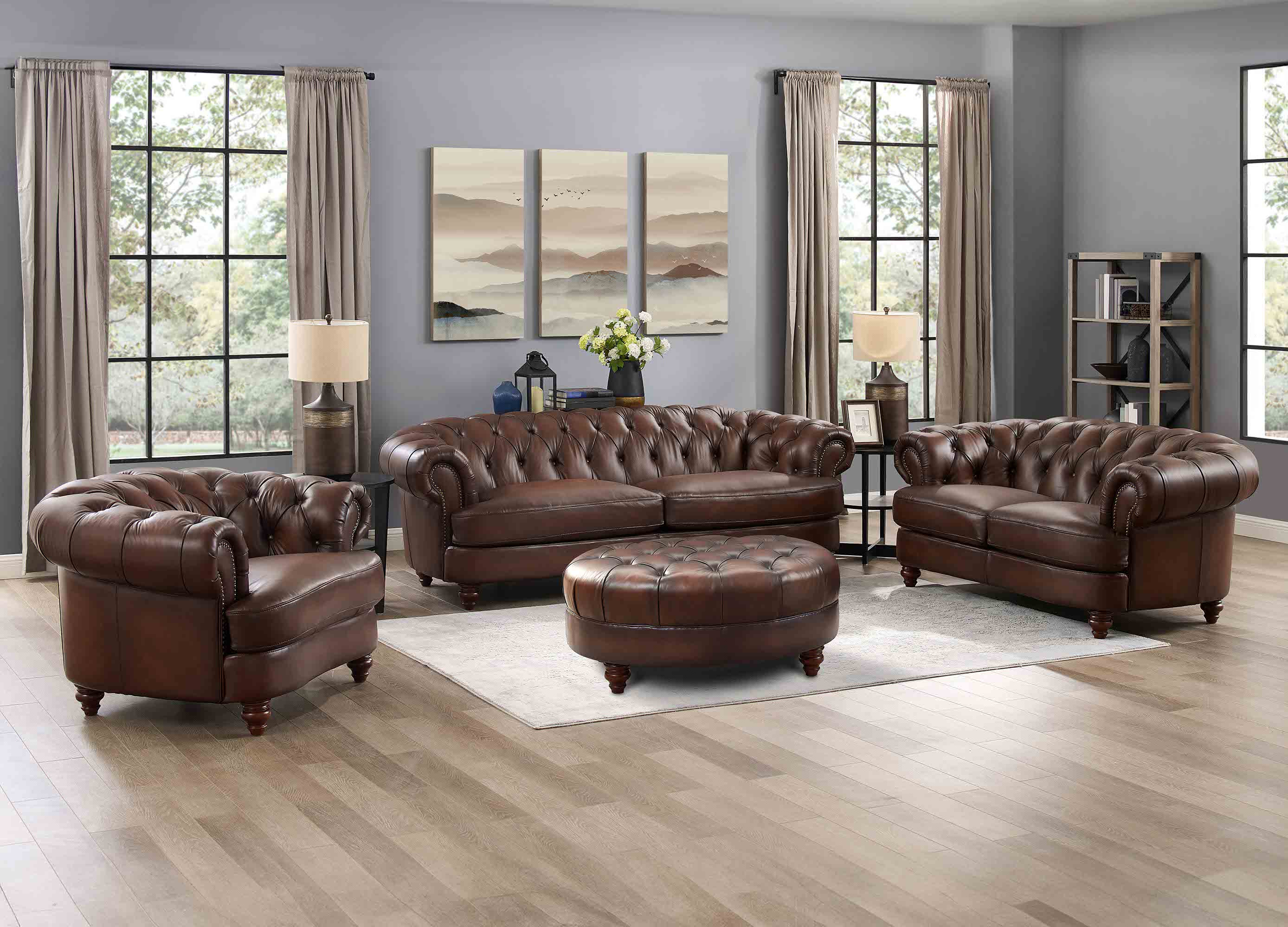 Brown leather sofa set in a living room with large windows and decor.